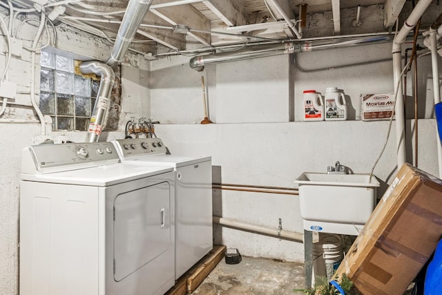 laundry area featuring laundry area, washing machine and dryer, and a sink