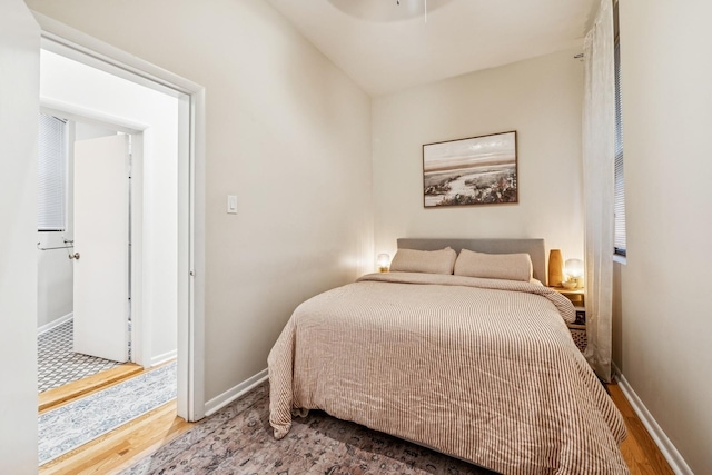 bedroom featuring wood finished floors and baseboards