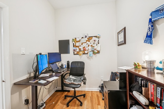 home office with wood finished floors and baseboards