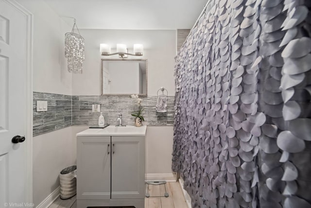 full bathroom with curtained shower, wood finished floors, and vanity