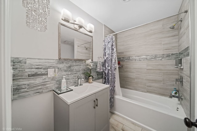 full bath with tasteful backsplash, vanity, tile walls, and shower / bathtub combination with curtain