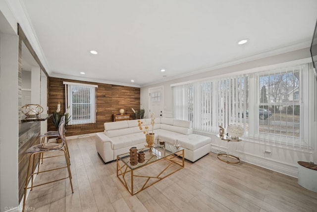 living room with crown molding, recessed lighting, and light wood-type flooring