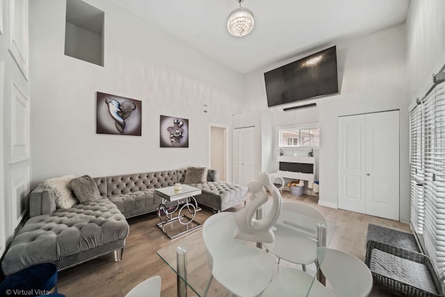 living area with a high ceiling and wood finished floors