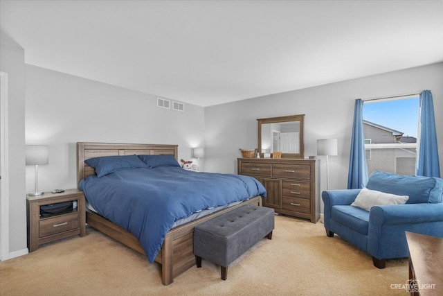 bedroom with baseboards, visible vents, and light carpet