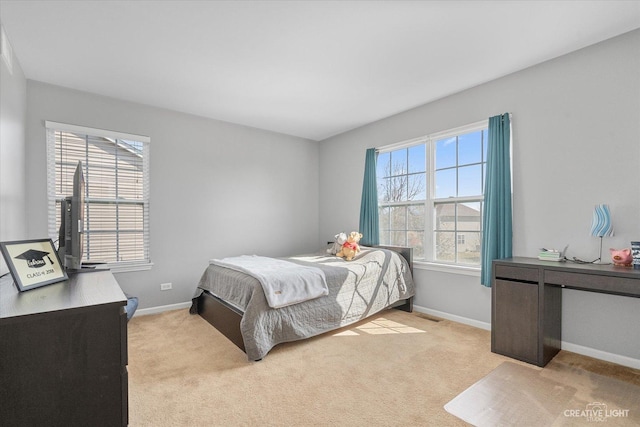 bedroom featuring multiple windows, baseboards, and carpet