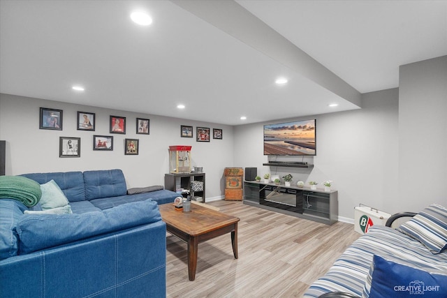 living room with recessed lighting, baseboards, and light wood-style flooring