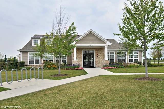 view of front of property featuring a front yard and stone siding