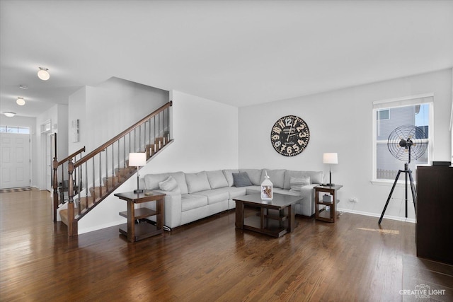 living room with stairway, wood finished floors, and baseboards