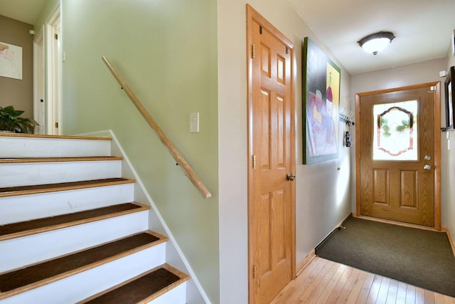 foyer entrance with hardwood / wood-style floors and stairway