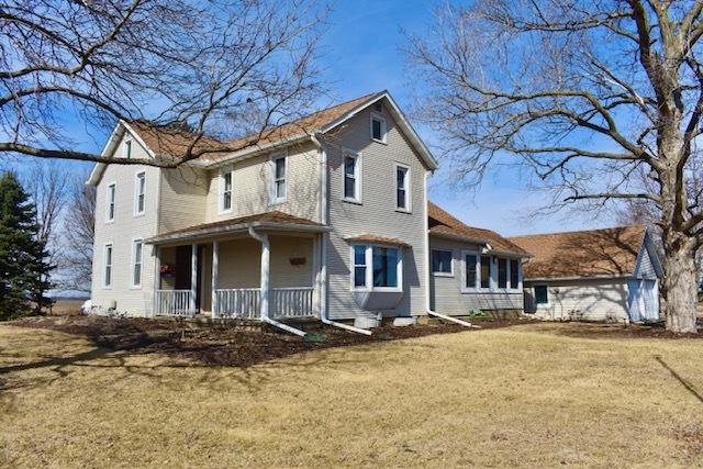 view of front of home with a porch and a front yard