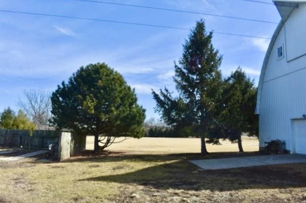 view of yard featuring a garage and fence