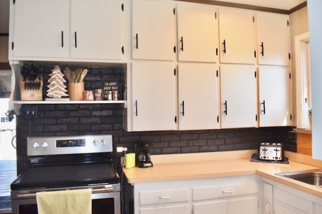 kitchen featuring white cabinetry, stainless steel electric range oven, and light countertops