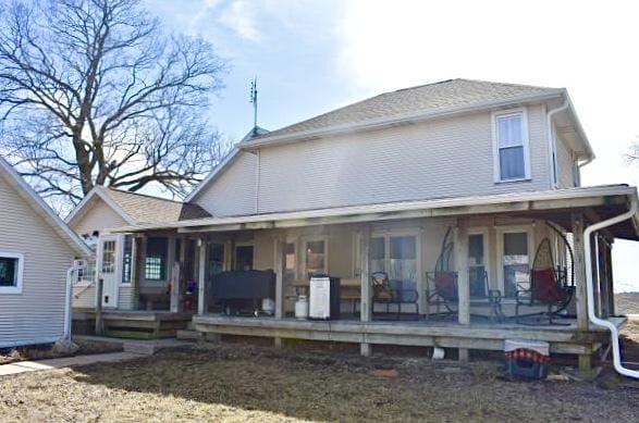 back of property featuring a porch