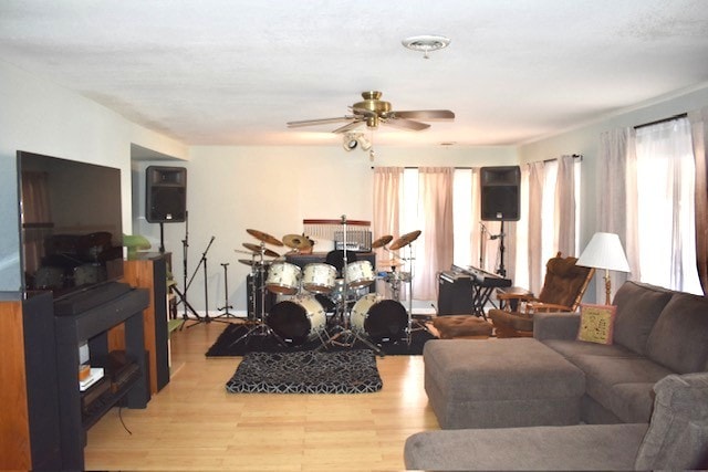 living area with wood finished floors and ceiling fan