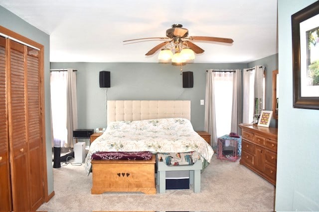 bedroom with carpet, a closet, and ceiling fan