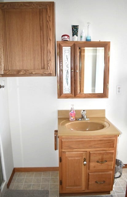 bathroom featuring baseboards and vanity