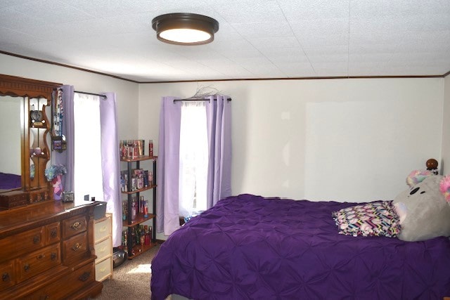 carpeted bedroom featuring crown molding