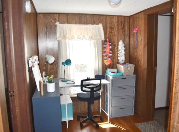 office featuring wood finished floors and wood walls