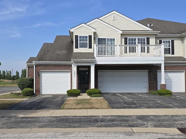 2401 Echelon Cir Unit C, Matteson, IL 60443 - traditional home with brick siding, a shingled roof, a balcony, and driveway