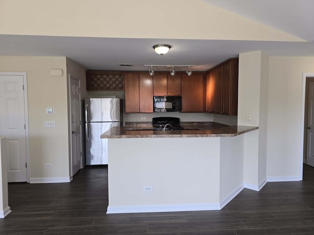 2401 Echelon Cir Unit C, Matteson, IL 60443 - kitchen with black microwave, freestanding refrigerator, track lighting, a peninsula, and dark wood-type flooring