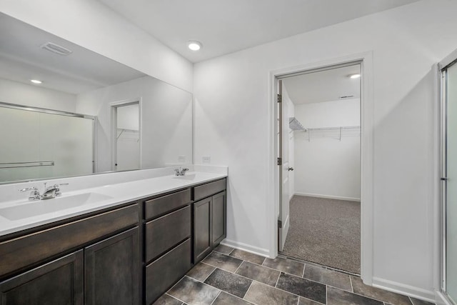 full bath featuring visible vents, a stall shower, and a sink