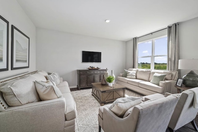 living room with baseboards and light wood-style flooring