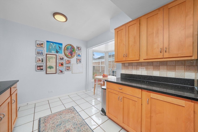 kitchen with decorative backsplash, baseboards, and light tile patterned flooring