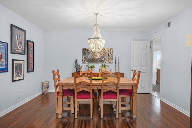 dining space featuring visible vents, baseboards, dark wood-style floors, and a chandelier