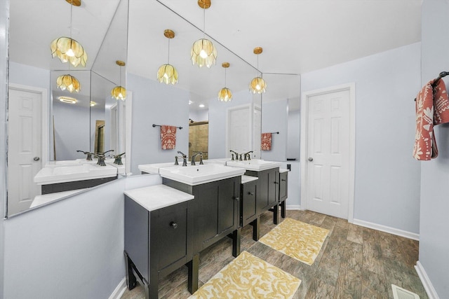 bathroom with a shower stall, wood finished floors, visible vents, and a sink