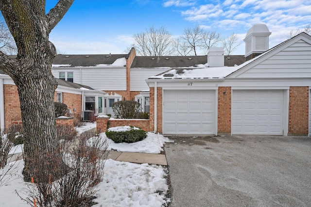 view of front of house featuring brick siding and central air condition unit