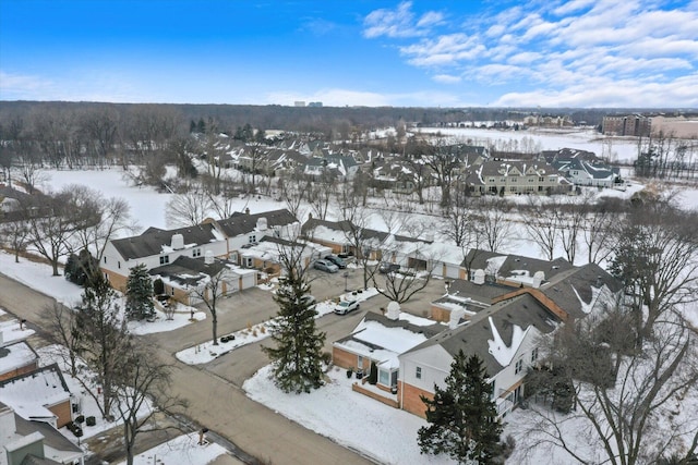 snowy aerial view with a residential view