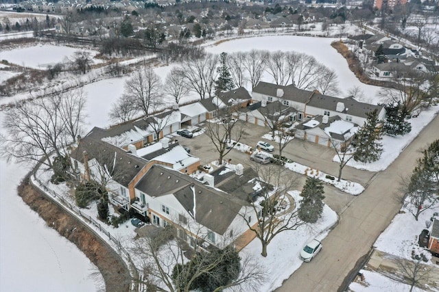 snowy aerial view with a residential view