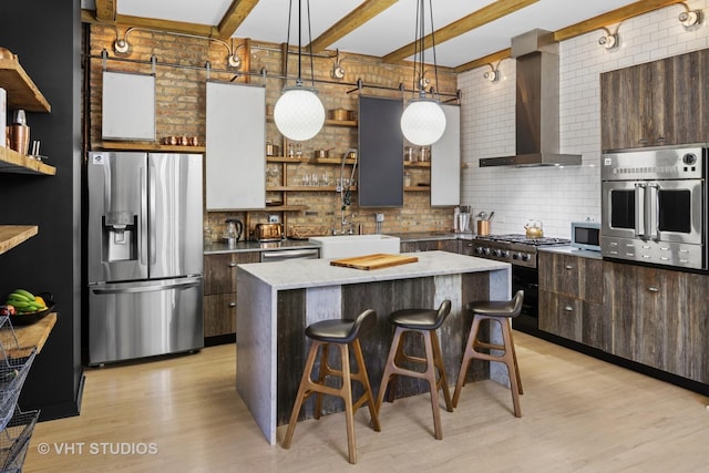 kitchen with open shelves, a sink, stainless steel appliances, wall chimney exhaust hood, and backsplash