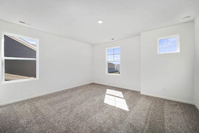 carpeted empty room with baseboards and visible vents