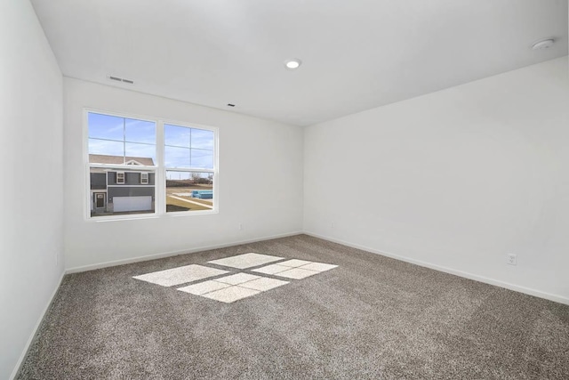 carpeted empty room featuring recessed lighting, visible vents, and baseboards