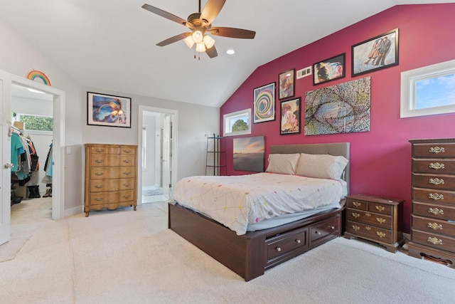 carpeted bedroom with multiple windows, lofted ceiling, and a spacious closet