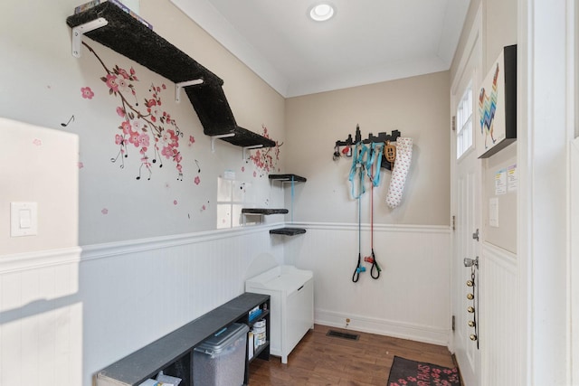 clothes washing area featuring visible vents, laundry area, wainscoting, wood finished floors, and independent washer and dryer