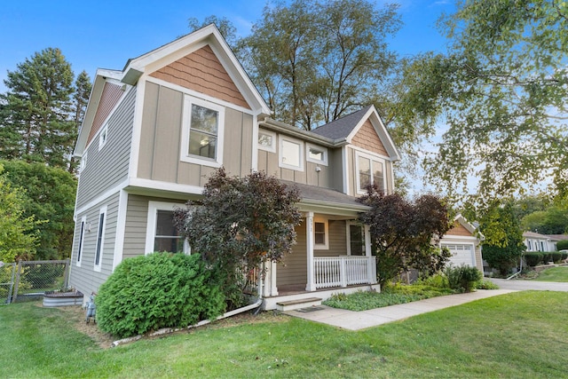 view of front facade with a porch, board and batten siding, a front lawn, and fence