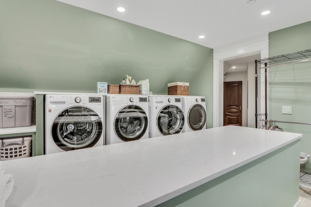 clothes washing area featuring washing machine and clothes dryer, laundry area, and recessed lighting