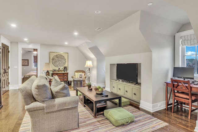 living area with recessed lighting, wood finished floors, and vaulted ceiling