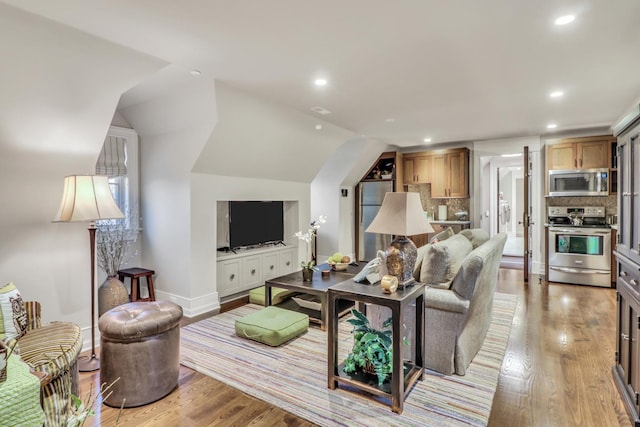 living area with recessed lighting, baseboards, and light wood-style floors