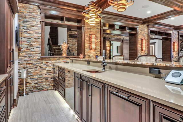 interior space featuring beam ceiling, crown molding, and a sink