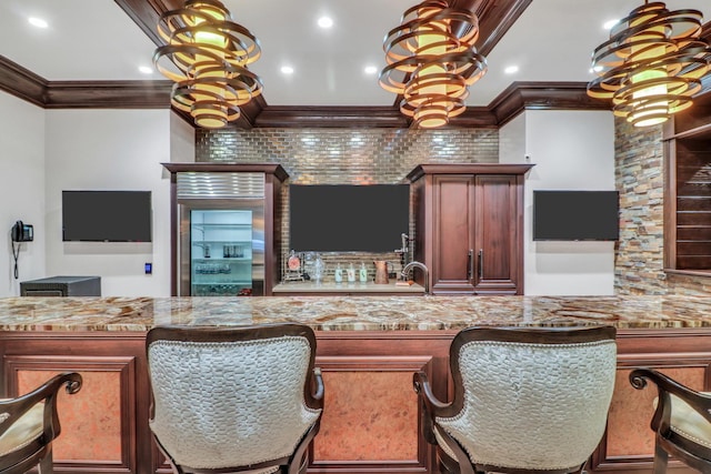 bar featuring recessed lighting, wet bar, ornamental molding, and hanging light fixtures