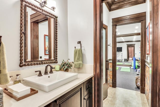 bathroom with vanity and ornamental molding