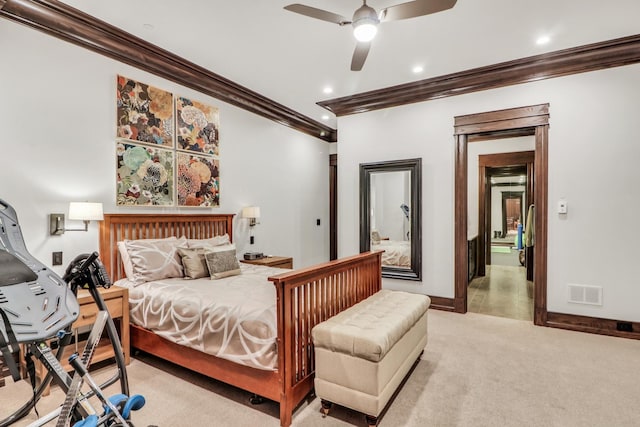 bedroom with visible vents, ornamental molding, baseboards, light colored carpet, and ceiling fan