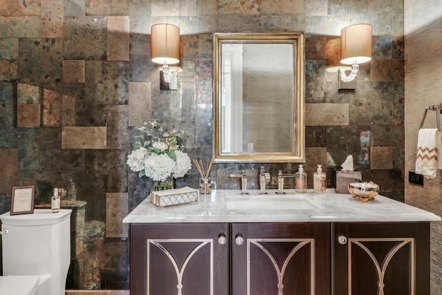 bathroom featuring backsplash, toilet, tile walls, and vanity