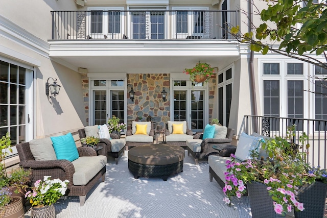 view of patio featuring an outdoor hangout area and a balcony