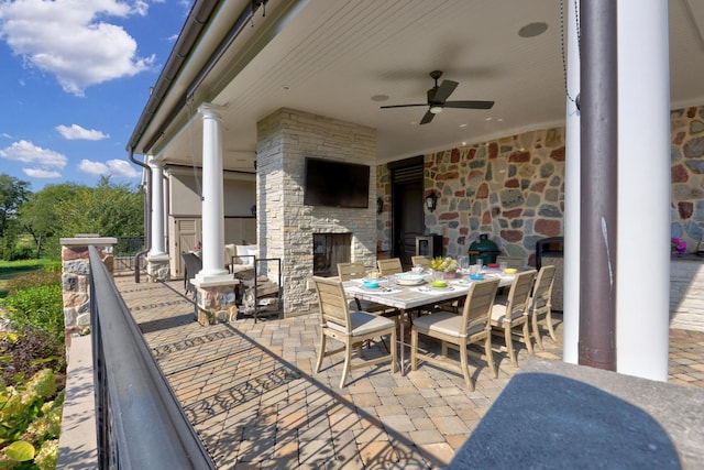 view of patio with outdoor dining space and a ceiling fan