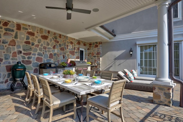 view of patio featuring area for grilling, outdoor dining area, and ceiling fan