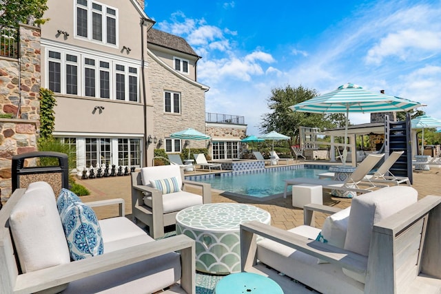 outdoor pool with an outdoor hangout area and a patio